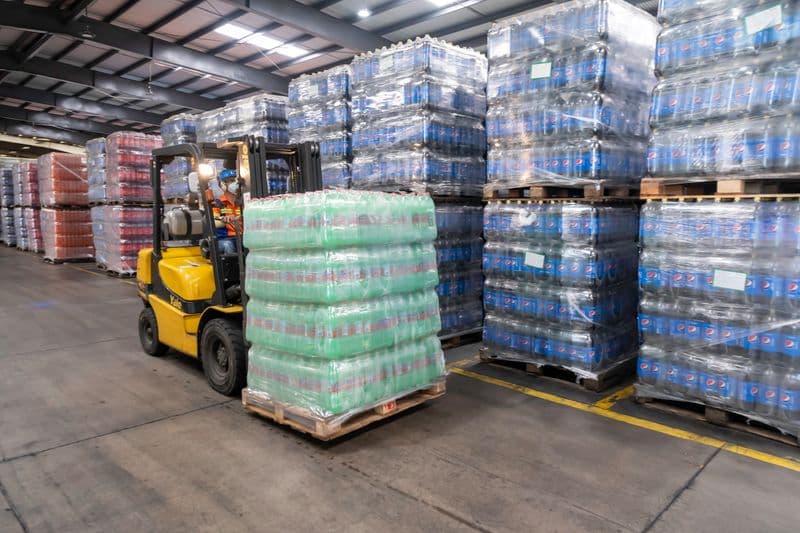 Forklift moving pallets in a warehouse